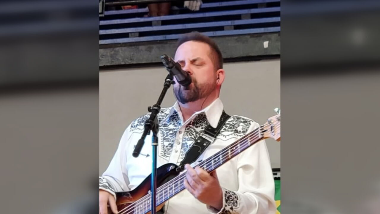 Jamie Via sings and plays guitar